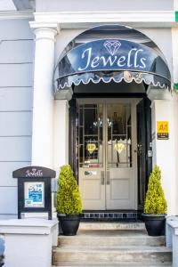 a store front with a blue awning on a building at Jewells Guest Accommodation in Plymouth