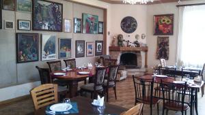 a restaurant with tables and chairs and a fireplace at Casanova Inn - Boutique Hotel in Dilijan