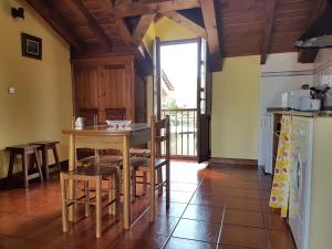 a kitchen with a table and chairs in a room at El Pedroso in Santillana del Mar