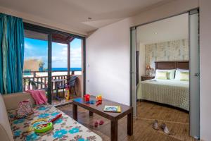 a bedroom with a bed and a view of the ocean at Koutrakis Suites by Estia in Sissi