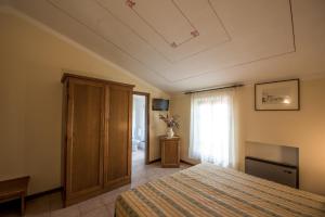 Postel nebo postele na pokoji v ubytování Albergo La Foresteria