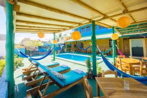 a patio with a hammock and a pool at Galapagos Verde Azul in Puerto Ayora