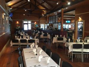a dining room with white tables and chairs at Winchelsea Motel in Winchelsea