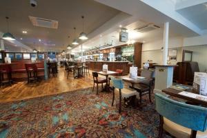 a restaurant with tables and chairs and a bar at The Bottle Kiln Wetherspoon in Harwich