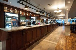 a bar with a long counter in a restaurant at The Bottle Kiln Wetherspoon in Harwich