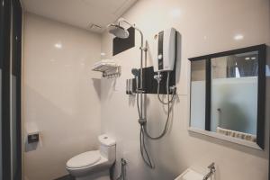 a bathroom with a shower and a toilet at V3 Hotel & Residence Seri Alam in Pasir Gudang