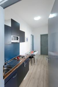 a kitchen with a sink and a stove top oven at B&B Piazza Duomo in Cerignola