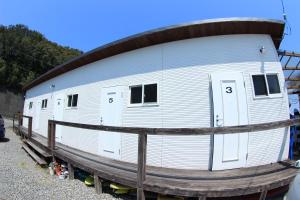 a large white trailer is sitting on a rail at PavilionSurf&Lodge in Shishikui +52 photos