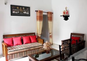 a living room with a couch and red pillows at Fortune Rest Villa in Marawila