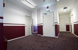 an empty hallway with doors in a building at Hotel & Hostel 10 in Gothenburg