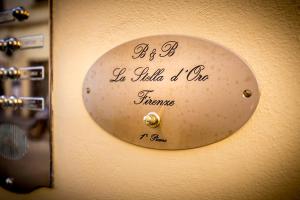 a clock on a wall with a sign on it at La Stella d'Oro B&B in Florence