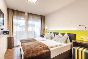 Postel nebo postele na pokoji v ubytování LEDERER Boutique Hotel