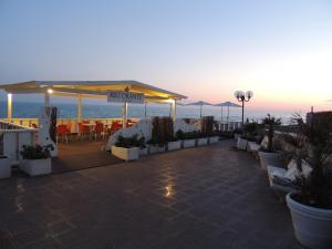 a patio with a table and chairs and the ocean at Hotel Residence Paguro in Siculiana Marina