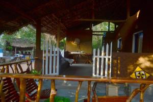 a wooden bench with a white fence in a room at Hidden Jungle Village in Nochchiyagama