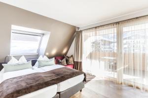 Postel nebo postele na pokoji v ubytování LEDERER Boutique Hotel