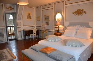 a bedroom with a large bed with two pillows at La Tour du Lion in Rochefort-en-Terre