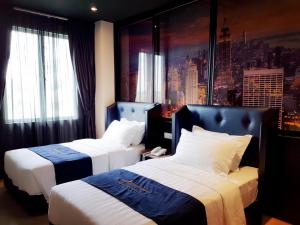 Postel nebo postele na pokoji v ubytování Manhattan Business Hotel TTDI