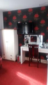 a room with a desk and a table with a chair at The Glendale in Skegness