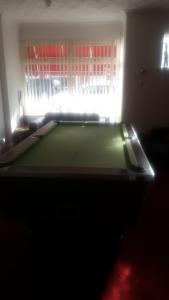 a room with a pool table in front of a window at The Glendale in Skegness