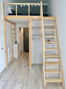 a bunk bed in a room with a ladder at Apartament Żelazna in Warsaw