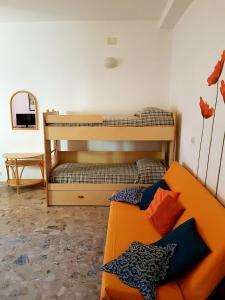 デイヴァ・マリーナにあるAppartamento Mare Mossoのリビングルーム(二段ベッド2台、ソファ付)