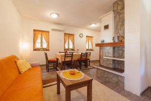 a living room with a couch and a table at Guest House Rustico in Korenica