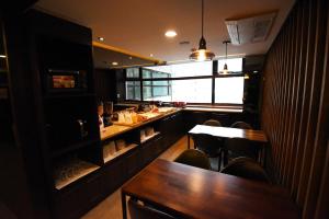 a restaurant with a table and chairs and a bar at 57 Myeongdong Hostel in Seoul