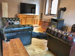 a living room with a couch and a wood stove at Predel House in Log pod Mangartom