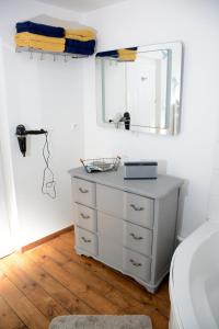 a bedroom with a white dresser and a mirror at Loft en bulles in Épernay