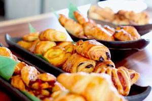 a bunch of trays of pastries on a table at Hotel Restaurant Au Boeuf Couronn&eacute; in Paris