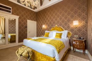 a bedroom with a large bed and a chandelier at Ai Patrizi di Venezia in Venice