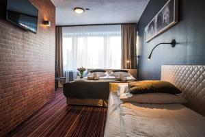 Voodi või voodid majutusasutuse Hotel Delta toas