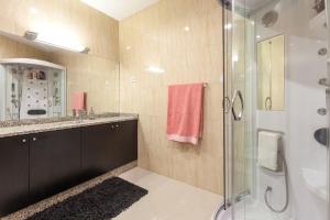 a bathroom with a glass shower and a sink at Casa dos Colados in Fafe +19 photos