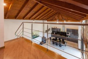 a room with a glass wall with a counter and chairs at Casa dos Colados in Fafe