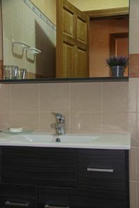 a bathroom with a sink and a mirror at Casa Rural Sierra De Coripe in Coripe