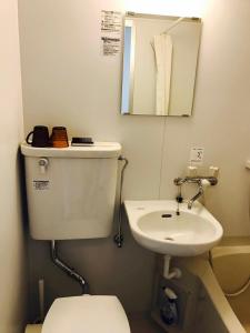 a bathroom with a toilet and a sink at Sun Heights Ikebukuro in Tokyo