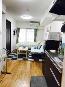 a small kitchen with a bed in a room at Sun Heights Ikebukuro in Tokyo
