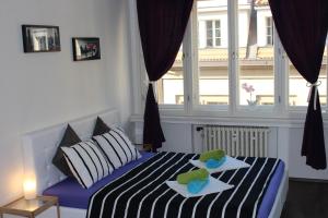 a bedroom with a bed with two towels on it at Go Native Prague Apartment in Prague