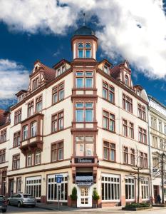 ein großes Gebäude mit einem Turm darüber in der Unterkunft The Heidelberg Exzellenz Hotel in Heidelberg