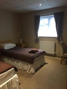 a bedroom with a bed and a window at The Fitzwilliam Hotel in Rotherham
