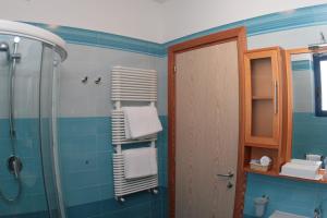 a bathroom with a shower and towels on the wall at Hotel Yria in Vieste