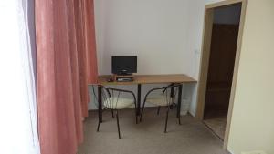 a room with a desk with a computer on it at Hotel THT in Polička