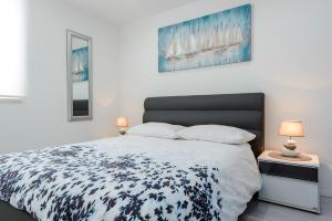 a bedroom with a bed with a black and white comforter at Apartment Andrea 1 in Dubrovnik