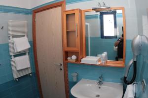 a bathroom with a sink and a mirror at Hotel Yria in Vieste