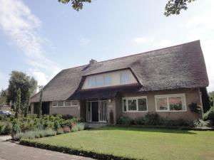 a brown house with a shingled roof at Riethove in Harlingen