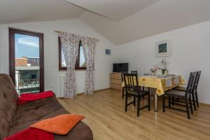 a living room with a table and chairs and a couch at Apartments Ana in Novigrad Istria