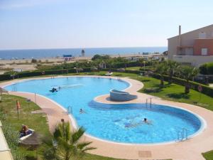 a group of people swimming in a pool at a resort at Vera Natura Urbanización Naturista in Vera