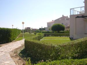 a hedge in front of a building with a yard at Vera Natura Urbanización Naturista in Vera