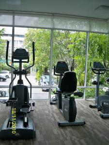 a gym with a row of exercise bikes in front of a large window at Studio in Haven in Bangkok