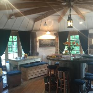 a kitchen with a bar and stools in a room at Lodge at Lochside in Bridgend of Lintrathen